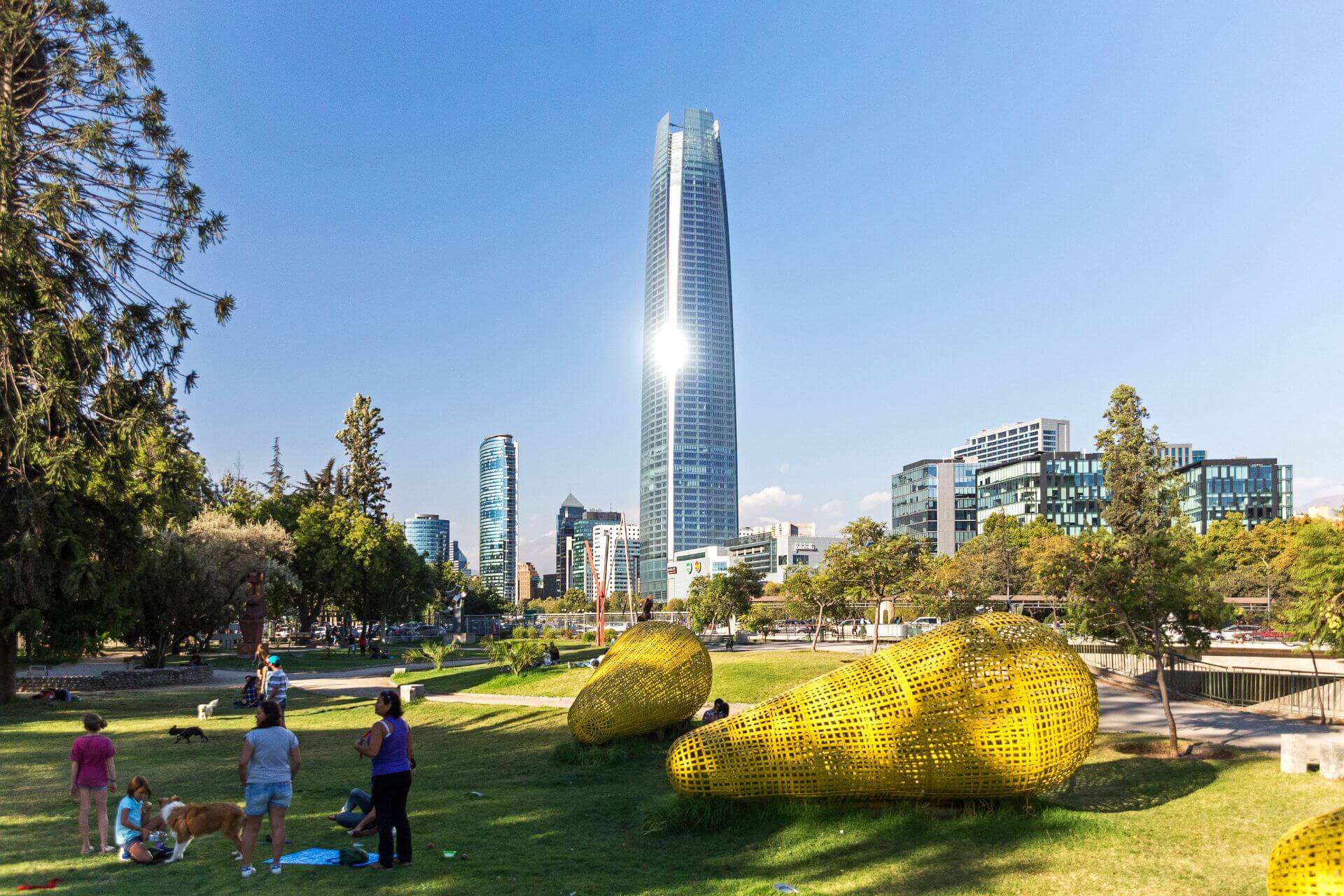 A weekday morning in a local city centre park, people relaxing on the grass.