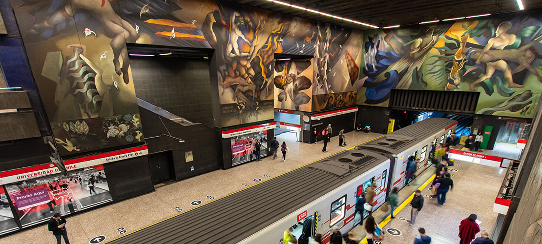 The vaulted platform at Universidad de Chile station, its mural running the full length of the wall